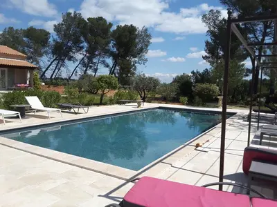 a swimming pool with blue water in a yard at mas clair de lune in Saint-Rémy-de-Provence