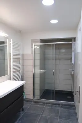 a bathroom with a shower with a glass door at Maison confortable à Ansouis dans Le Luberon in Ansouis