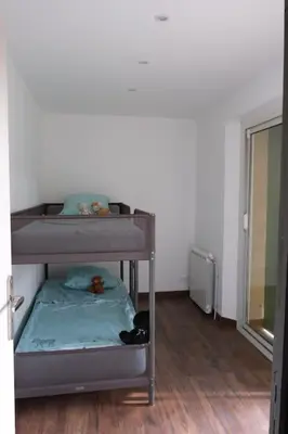 a small bunk bed in a room with a window at Maison confortable à Ansouis dans Le Luberon in Ansouis