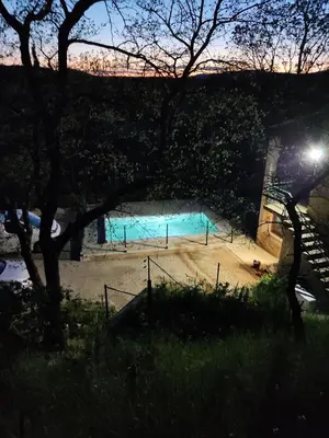 a swimming pool in the middle of a park at night at Maison confortable à Ansouis dans Le Luberon in Ansouis