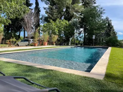 a swimming pool in the middle of a yard at Superbe bas de villaIX - Maison Odonata in Aix-en-Provence