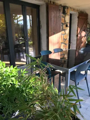 a patio with a table and chairs on a porch at Superbe bas de villaIX - Maison Odonata in Aix-en-Provence