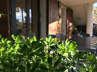 a group of chairs sitting on a porch at Superbe bas de villaIX - Maison Odonata in Aix-en-Provence