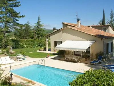 a villa with a swimming pool and a house at Le grand Liodrey in Céreste