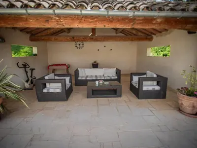 a patio with couches and tables in a building at Liodrey in Céreste