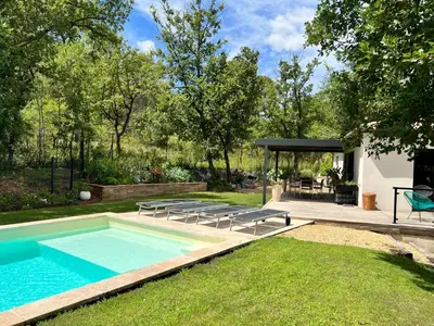 a backyard with a swimming pool and a house at Luxury Villa with Pool en Provence in Le Puy-Sainte-Réparade
