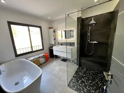 a bathroom with a tub and a shower and a sink at Luxury Villa with Pool en Provence in Le Puy-Sainte-Réparade