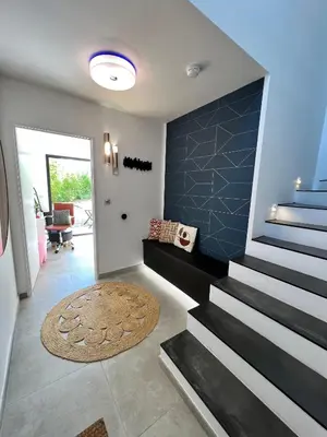 a living room with a staircase and a rug at Luxury Villa with Pool en Provence in Le Puy-Sainte-Réparade