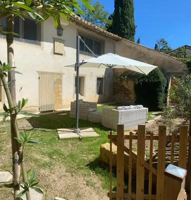 a white umbrella in front of a house at Mazet au pied des Alpilles, avec Piscine & Pétanque in Salon-de-Provence