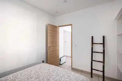 a bedroom with a bed and a closet and a ladder at Entre Aix et Marseille in Rognac