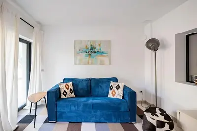 a blue couch sitting in a living room at Entre Aix et Marseille in Rognac