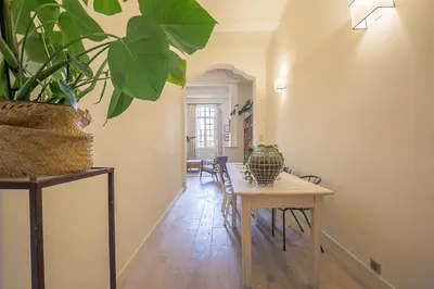 a dining room with a table and a potted plant at Le Cocon Aixois in Aix-en-Provence