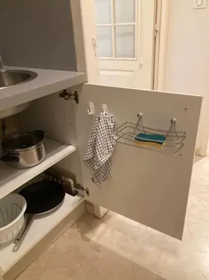 a kitchen with a sink and a shelf with utensils at Le Fernandol by La Familia in Aix-en-Provence