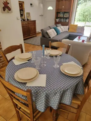 a table with plates and glasses on it in a living room at Maison T4, campagne Provençale calme, tout confort in Lambesc