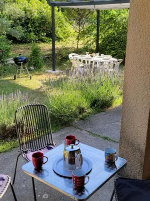 a table with a tea pot and cups on it at Maison T4, campagne Provençale calme, tout confort in Lambesc