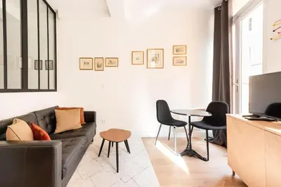 a living room with a couch and a table at Le Boulegon by La Familia in Aix-en-Provence