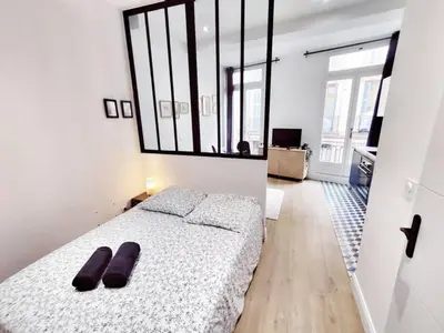 a bedroom with a bed with two slippers on it at Le Boulegon by La Familia in Aix-en-Provence