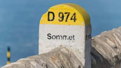 a white and yellow sign on top of a mountain at ENTRE VENTOUX ET LUBERON Chambre d'hôte in Sault-de-Vaucluse