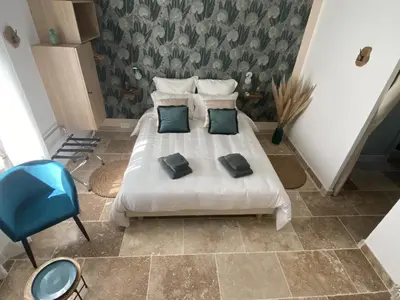 a bedroom with a white bed with two pillows at Chambre d'hôtes Alizé, Le Moulin de Prédelles in Reillanne
