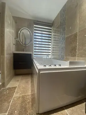 a bathroom with a large tub and a mirror at Chambre d'hôtes Alizé, Le Moulin de Prédelles in Reillanne