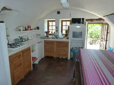 a kitchen with white counters and a stove top oven at Provencal farmhous Lubéron, swimming pool in Revest-des-Brousses
