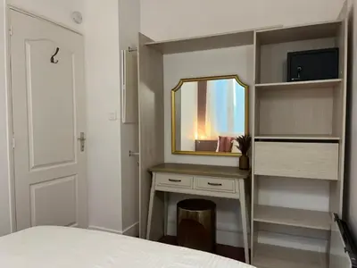 a bedroom with a vanity with a mirror and a bed at Charmant appartement T2 / 58 m2 / 4 personnes in Aix-en-Provence