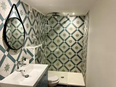 a bathroom with a sink and a toilet and a mirror at Spacieux appartement T4 / 70 m2 8 personnes in Aix-en-Provence