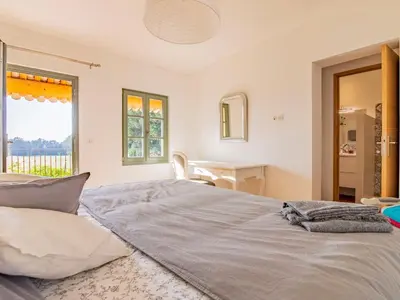 a bedroom with a bed and a desk and a window at Holiday Home Le Mas de Marius by Interhome in Cavaillon