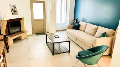 a living room with a couch and a chair at Les Iris in Céreste