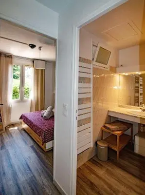 a bedroom with a bed and a sink in a room at Les quatres loges in Aix-en-Provence
