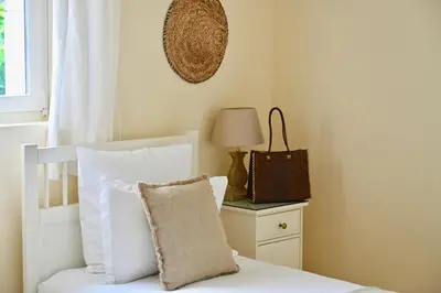 a bedroom with a bed with a pillow and a lamp at La Villa Baronnette in Cabrières-dʼAvignon