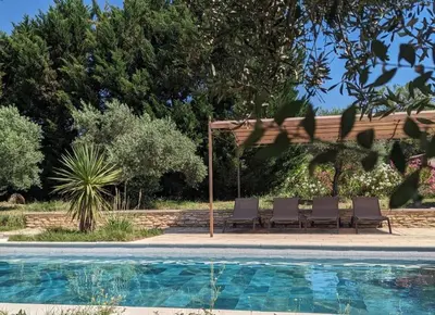 a group of chairs sitting next to a swimming pool at Rêve en Lubéron in Lauris