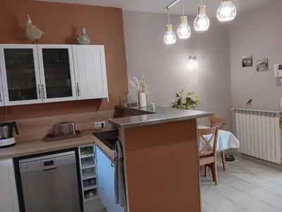 a kitchen with white cabinets and a counter top at La villa MARIE in Cavaillon
