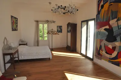 a bedroom with a bed and a painting on the wall at Pavillon de Beauregard in Aix-en-Provence