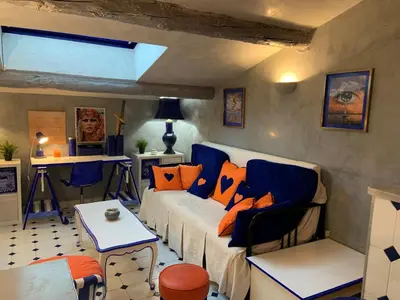a living room with a white couch and orange pillows at Appartement de Luxe ,