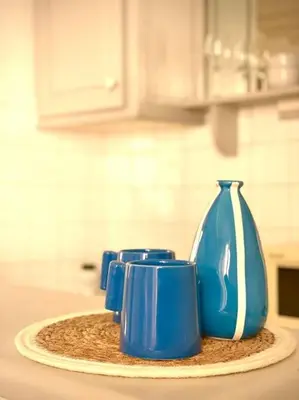 a group of blue mugs sitting on top of a counter at Studio le Méditerranée in Aix-en-Provence