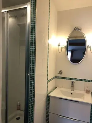 a bathroom with a shower and a sink and a mirror at Appartement avec terrasse. in Apt