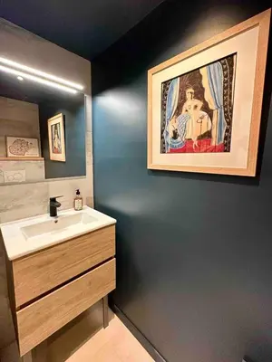a bathroom with a sink and a painting on the wall at Centre ville AIX - Terrasse / Ascenseur - Rénové in Aix-en-Provence
