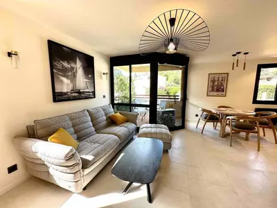 a living room with a couch and a table at Centre ville AIX - Terrasse / Ascenseur - Rénové in Aix-en-Provence