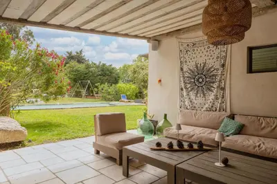 a living room with a couch and a table at Mas Le Cerf in Eyragues