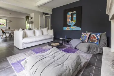 a living room with a couch and a table at Mas Le Cerf in Eyragues