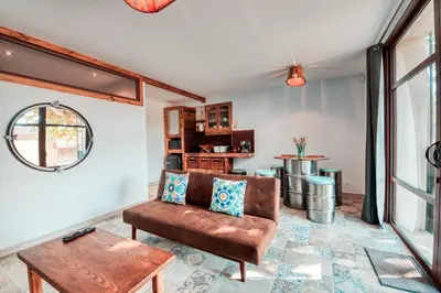 a living room with a couch and a table at La Remise en Forme in Entraigues-sur-la-Sorgue