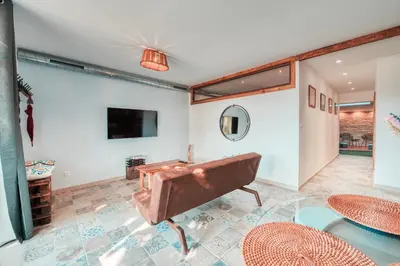 a living room with a couch and a table at La Remise en Forme in Entraigues-sur-la-Sorgue