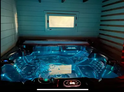a blue tub in a room with a window at Une Pause Douceur - Suite All in Wood in Eyguières