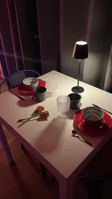 a table with bowls and plates and a lamp on it at Une Pause Douceur - Suite All in Wood in Eyguières