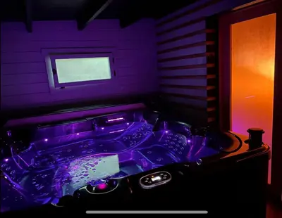 a purple bathroom with a tub in a room at Une Pause Douceur - Suite All in Wood in Eyguières