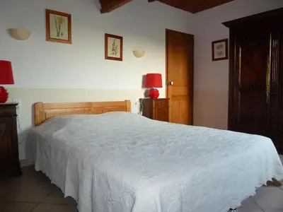 a bedroom with a bed with a white bedspread at Les Tournesols in Saint-Andiol