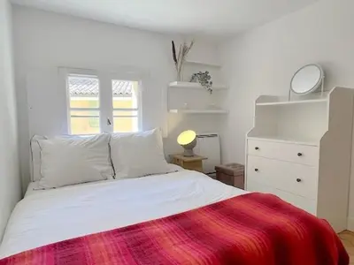 a bedroom with a white bed with a red blanket at LUXURY Enchanting Duplex Aix Center in Aix-en-Provence