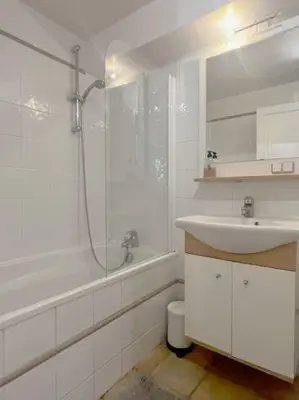 a white bathroom with a sink and a shower at LUXURY Enchanting Duplex Aix Center in Aix-en-Provence