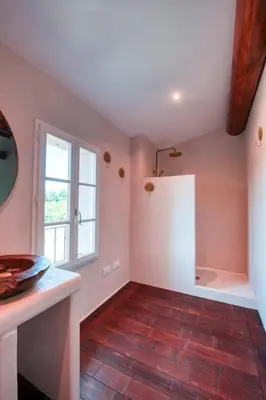 a kitchen with a white refrigerator and a window at Le Domaine du Printemps in Monteux